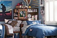 a blue shared teen boy bedroom rich stained beds, a storage unit, a sport-inspired gallery wall and baseball items on the wall