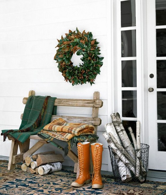 Logs usually add coziness to any space so with a nice wreath and a rustic bench they could turn your porch quite cozy.