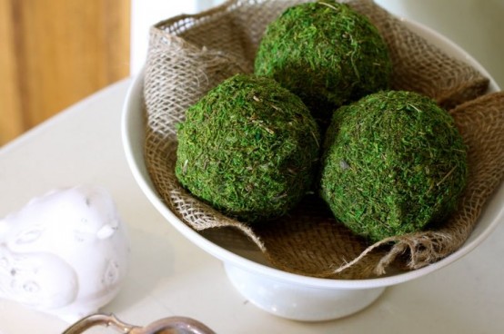 a bowl with burlap and moss balls is a cool centerpiece idea for spring, it feels rustic