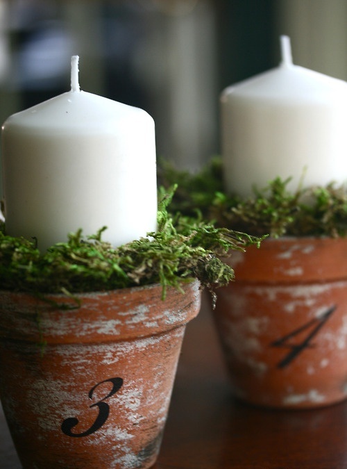 pots with moss and large pillar candles are nice for fresh and stylish spring decor