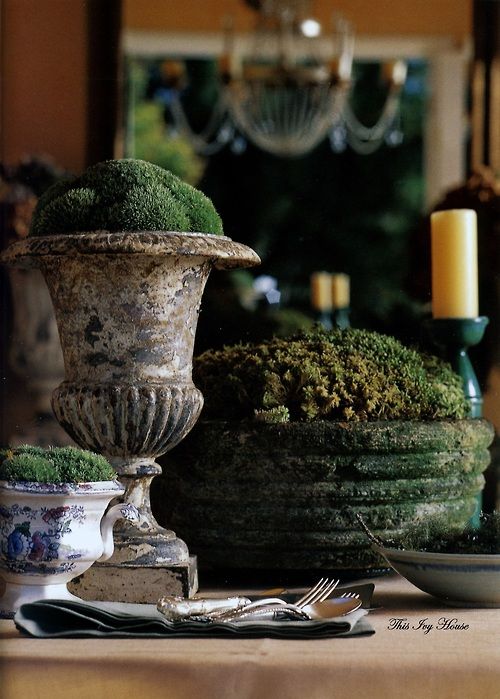 a vintage urn and bowl filled with moss are cool decorations or centerpieces for a spring tablescape