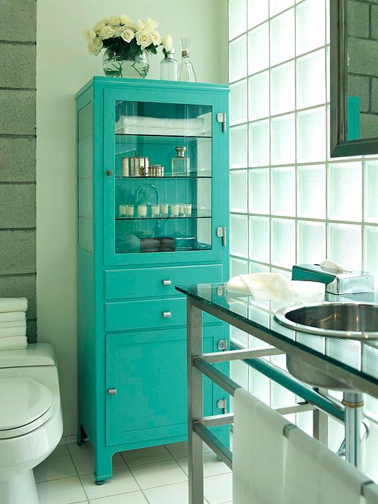 a stylish vintage storage cabinet with a glass doors and drawers done turquoise will add color and interest to your bathroom or some other room