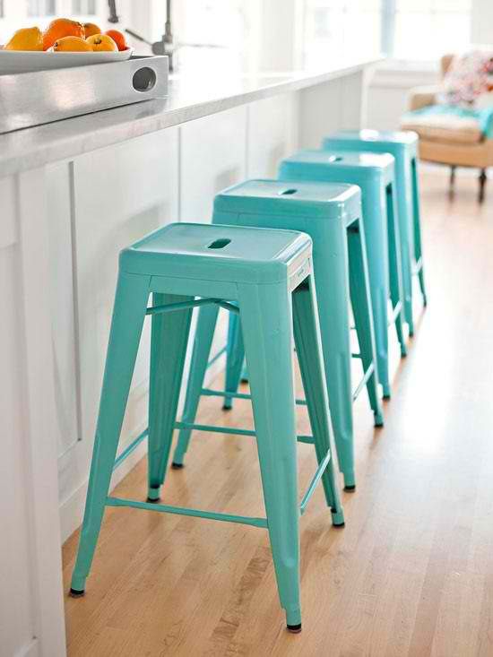 a row of turquoise metal stools will add a touch of color and fun to your kitchen and will make it more welcoming and lively