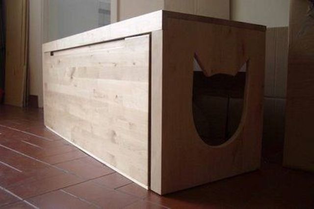 a wooden cabinet with a drawer and a cat head shaped entrance is easy to use and easy to clean