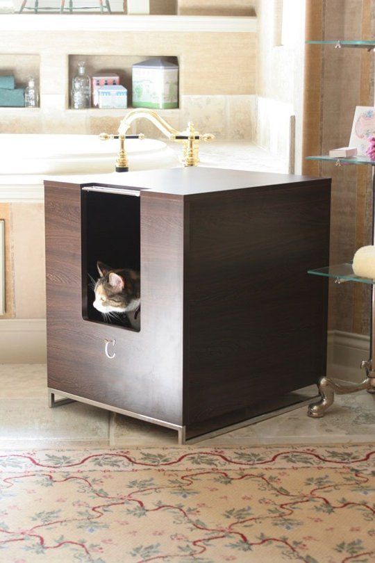 a dark stained plywood box with a cat litter box inside and a simple entrance placed in a bathroom