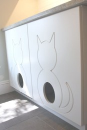 a large cabinet with a couple of litter boxes inside and two entrances for kitties is modern and simple