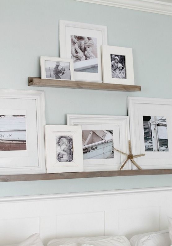 wooden ledges of various sizes with black and white artworks in frames are lovely for creating your own gallery wall in any space