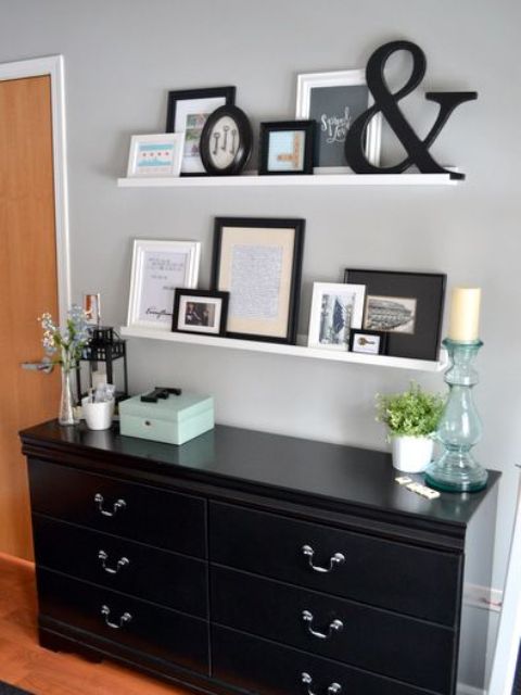 white ledges with artworks, ampersands, photos and other stuff are great to create an elegant gallery wall