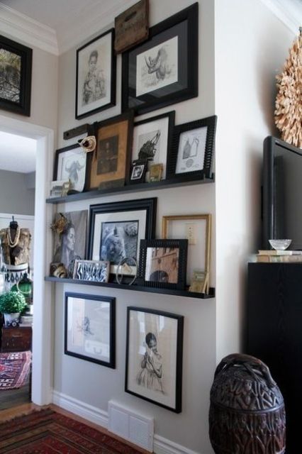 an awkward nook used to advantage with black ledges and lots of artworks and figurines is a fresh idea to rock