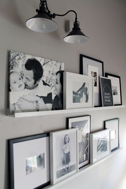 an elegant gallery wall done with white ledges and with black and white artworks in frames is a veyr stylish idea that will fit many spaces