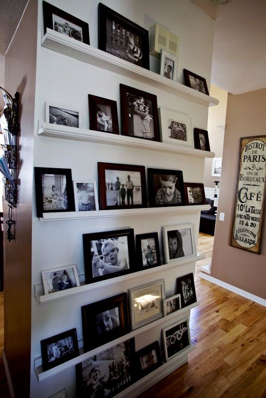 an awkward nook done with ledges and with black and white family photos is a very cozy and warm space in the house