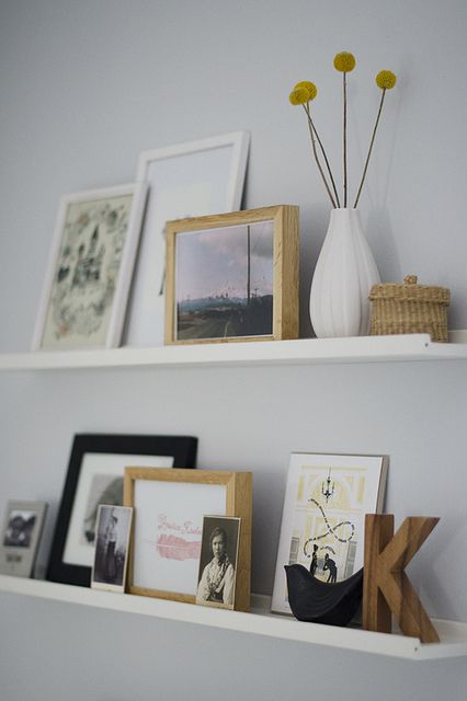 ledges with artworks, monograms, photos, billy balls and mini baskets are a nice way to create your own gallery wall with various stuff