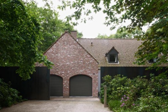 Country Home With Futuristic Steel Wall Around It