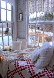 white crochet curtains, pinecone posies, knit bedding and plaid textiles plus candles for a winter-like space