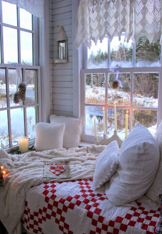 white crochet curtains, pinecone posies, knit bedding and plaid textiles plus candles for a winter-like space
