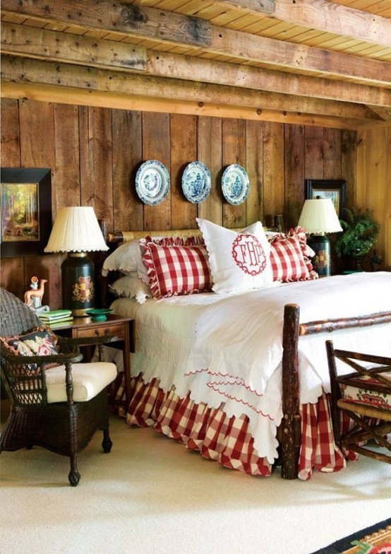 rough wood, plaid bedding, a rough wood bed and a fern arrangement make the bedroom look very wintry