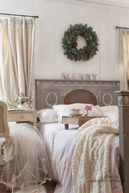 knit blankts and a single evergreen and pinecone wreath on the wall make your bedroom more holiday-like
