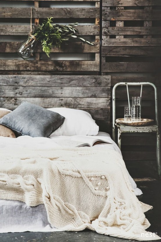 a white chunky knit blanket and some greenery in a jar for a stylish winter bedroom look