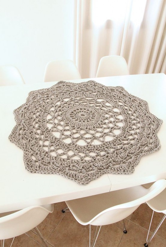 a grey crocheted doily like this one can accent your table or the centerpiece your have during the meal or not