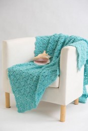 a crochet blanket is always a good idea as it will make your comfortable and cozy and it may add a bit of color to the space