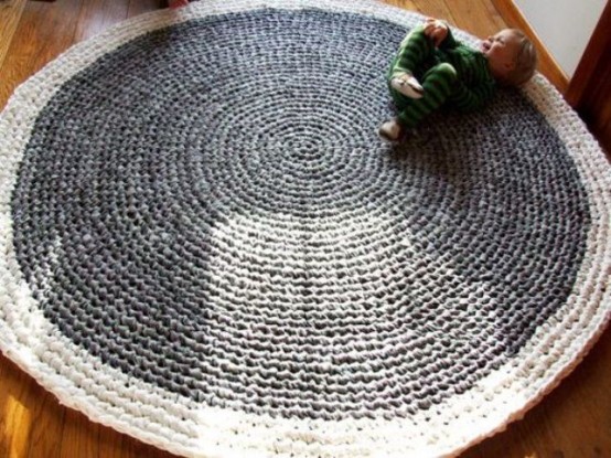 an oversized round crocheted rug is a beautiful idea for a kid's room and it will make playing on the floor much cozier and safer