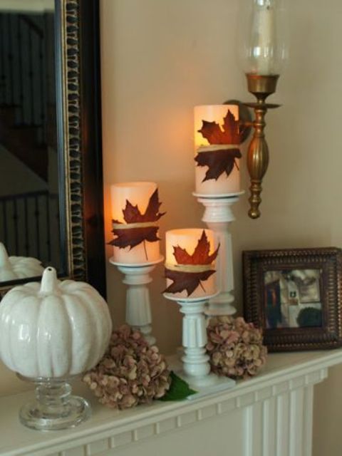 wrap candles with fall leaves and place them on candleholders to make your space look ultimately cozy