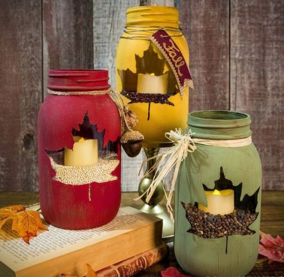 mustard, burgundy and green candle lanterns with leaf cutouts are very beautiful, bold and can be DIYed