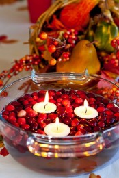 a bowl with cranberries and floating candles is an easy and very cool rustic centerpiece for the fall