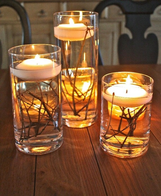 tall glasses with twigs and floating candles on top are nice fall decorations you can make very fast