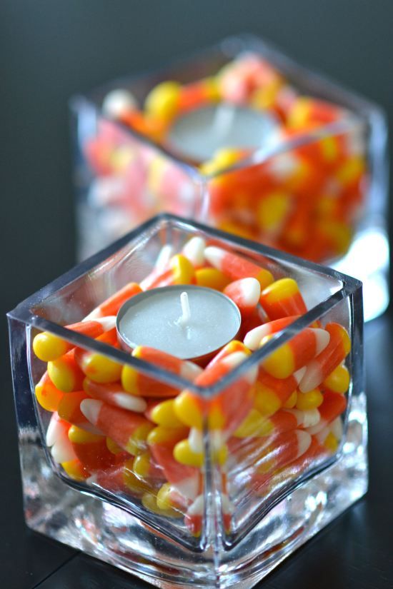 square glasses filled with candy corns and with tealights on top are lovely fall decorations you may rock anywhere you want