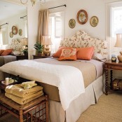 a bright fall-inspired bedroom with a floral upolstered bed, touches of neutrals and muted shades plus orange accents