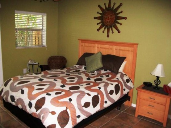 a colorful fall bedroom done in chocolate brown, green, rust and burgundy plus some pattern