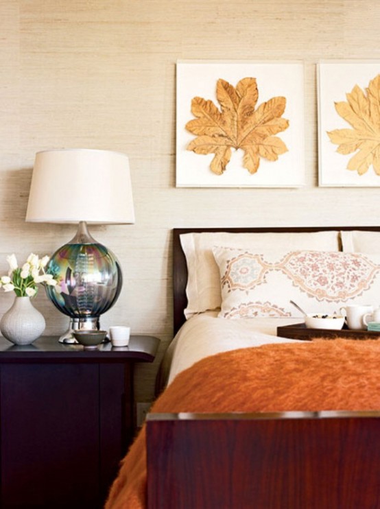 a fall bedroom with burgundy and purple touches, rust and orange decor and some touches of gold that bring a fall feel