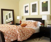 black, chocolate brown and touches of orange make this bedroom really fall-like