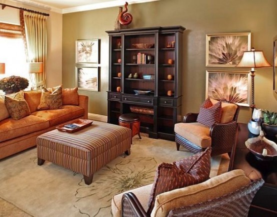 an orange sofa, printed pillows and an ottoman make up a bright fall-colored space