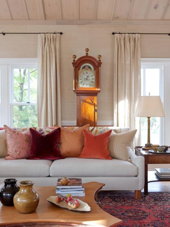 bright fall-colored pillows are enough to bring a fall feel to the living room