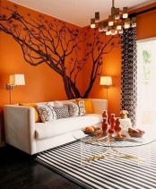 statement orange walls and a tree for hinting that it’s fall time – make a tree with decals to remove it when not needed