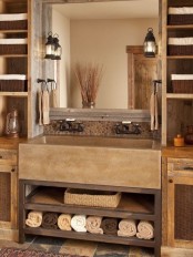an earthy-tone farmhouse bathroom with tiles, wooden storage units on both sides and a concrete sink