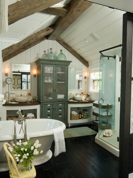 a vintage farmhouse bathroom with wooden beams, vintage furniture, a shower and a free standing bathtub