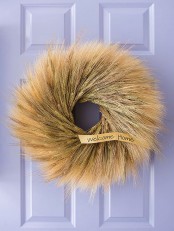 a lush wheat wreath with a tiny tag is a fantastic and long-lasting front door decoration for the fall