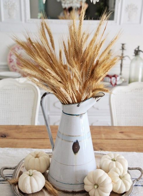 a metal jug with wheat and white pumpkins around is a vintage farmhouse centerpiece that inspires