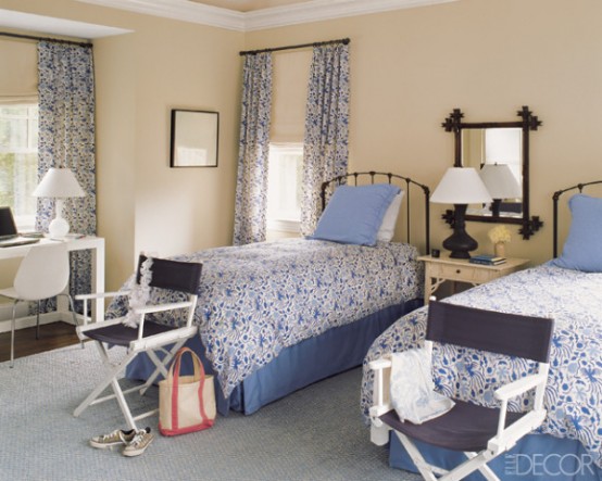 Shared bedroom with blue bedding and curtains. 