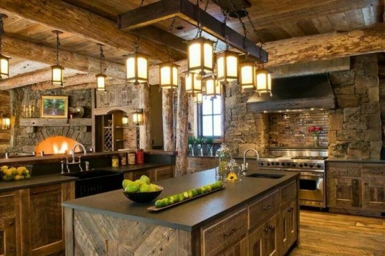 a chalet kitchen decorated with reclaimed wood and stone, vintage lanterns over the tables, a hearth and dark stone countetops