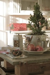 a tabletop Christmas tree, nuts and pomegranates make the kitchen feel like holidays at once