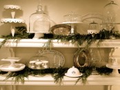 evergreen garlands placed right on the shelves add a rustic and natural feel to the kitchen