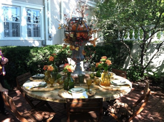 Centerpieces with pumpkins and twigs are perfect for warm evening dinners.