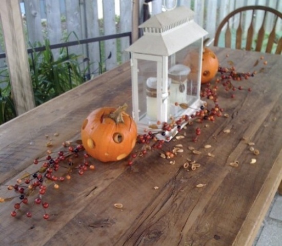Red berries, lanterns with candles and pumpkins is an ultimate mix you could use for your decor.