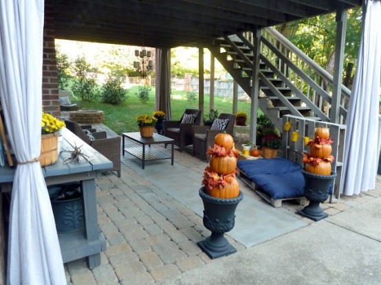 By layering pumpkins in vases and covering them with dried leaves  you can make yourself a beautiful Autumn decor.