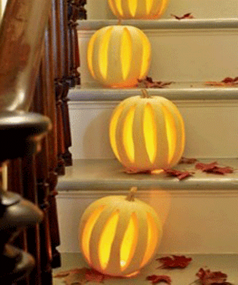 Cozy Fall Staircase Decor Ideas LED lights in hollow pumpkins where thin strips are cut out would create amazing atmosphere lying on the threads.
