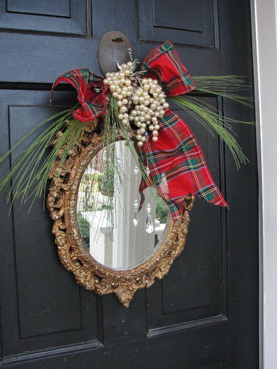 a mirror in an ornated frame, with evergreens, pearls and a red plaid bow is a creative alternative to a usual Christmas wreath